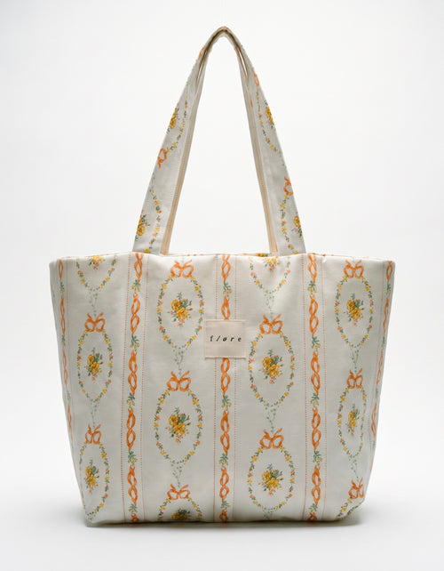 Patterned tote bag with floral design on a white background